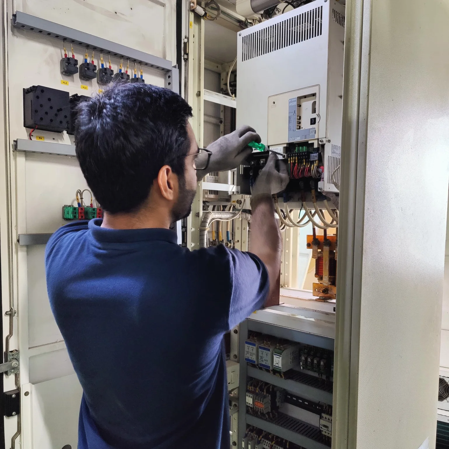 industryPRO service engineer diagnosing a control panel on site